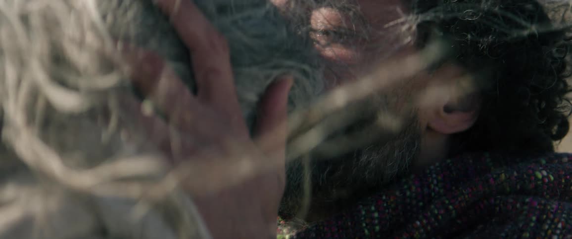 A man kisses a woman on the forehead