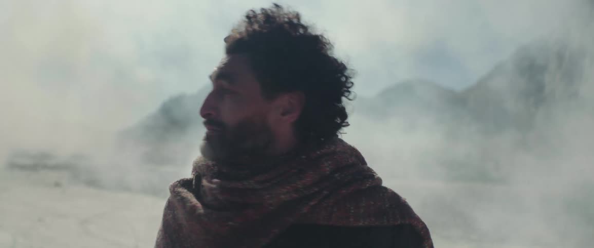 A man is turning around in the smoke