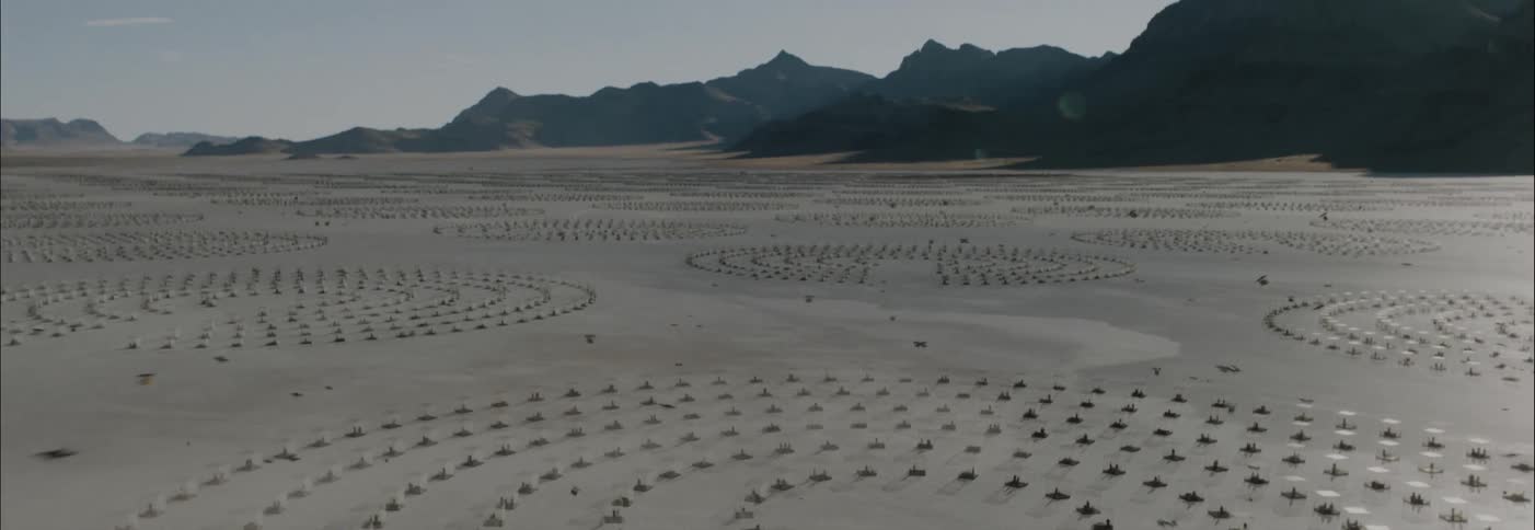 Drones flying in sci-fi dystopic habitat desert landscape