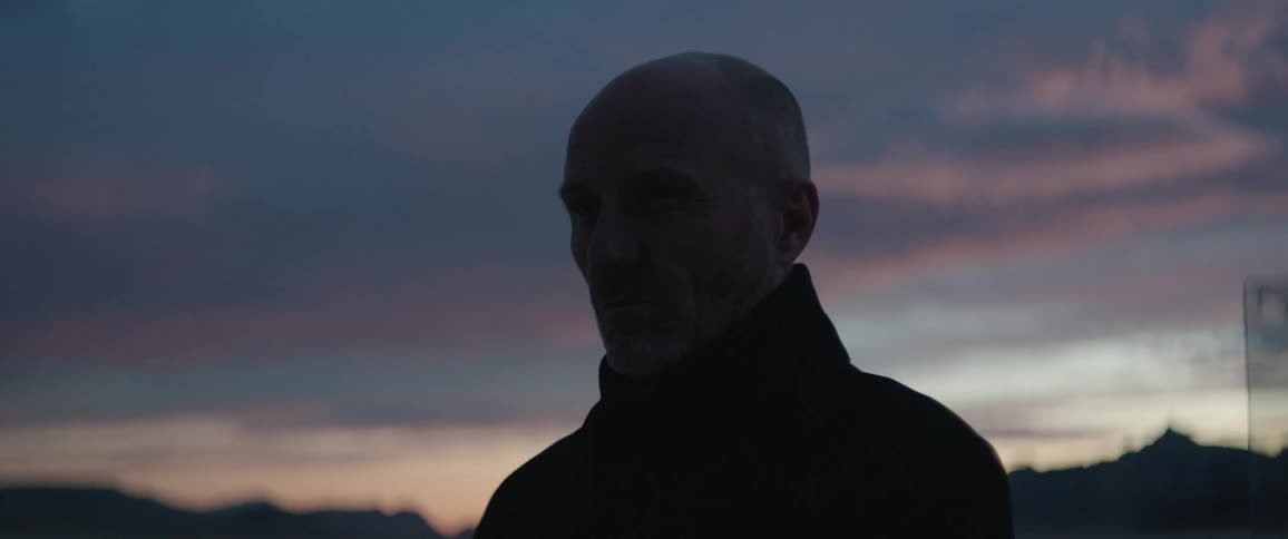 A man standing outside nods his head in approval