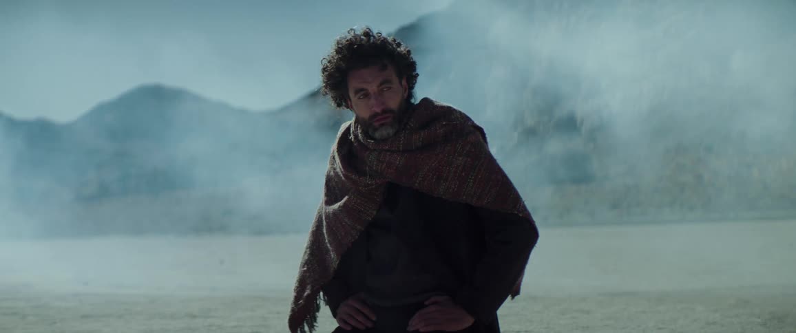 A man is standing in the desert