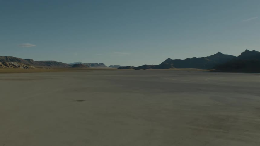 Desert fills area between mountains and stretches toward the horizon
