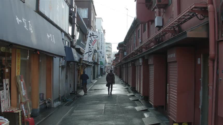 A man walks down a city alley