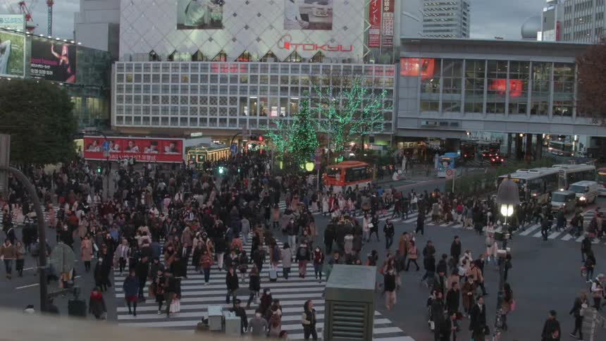 Pedestrians cross a busy city street
