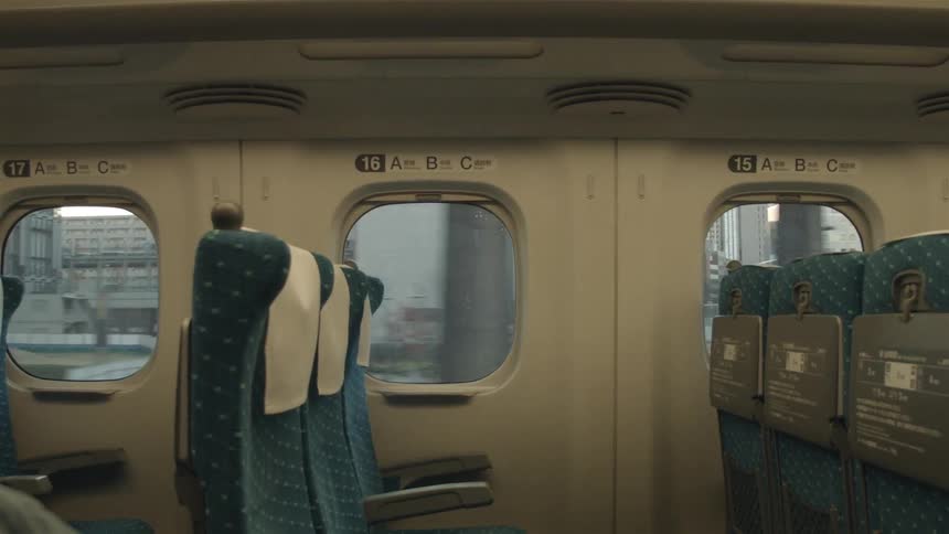 Empty seats as a commuter train travels through a city