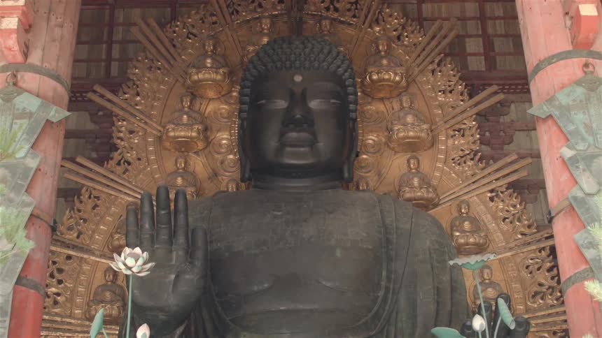 A statue surrounded by plants
