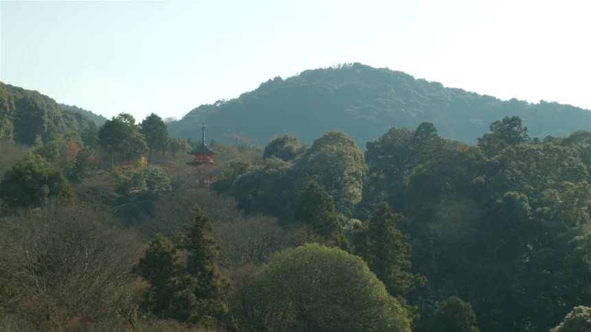 A tower sits in the green on a hillside