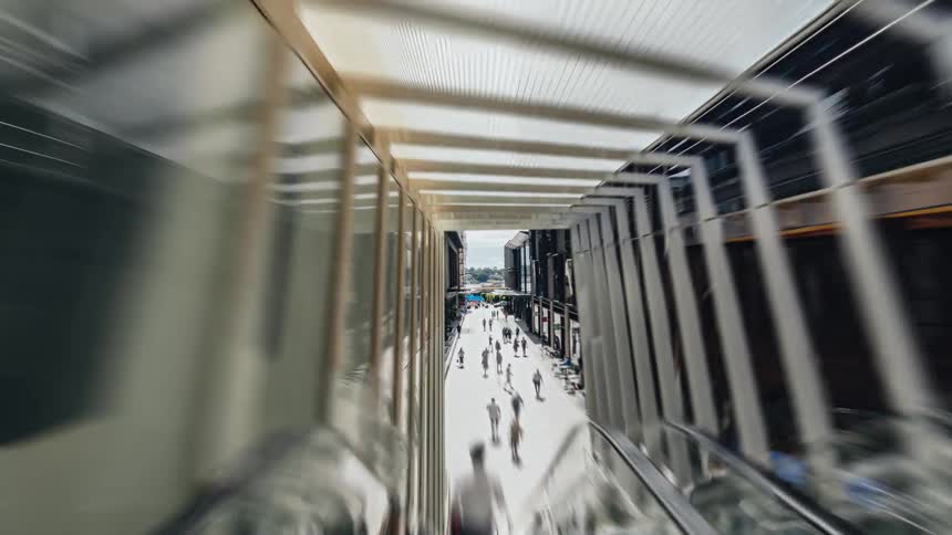 Pedestrians walking on a busy city sidewalk