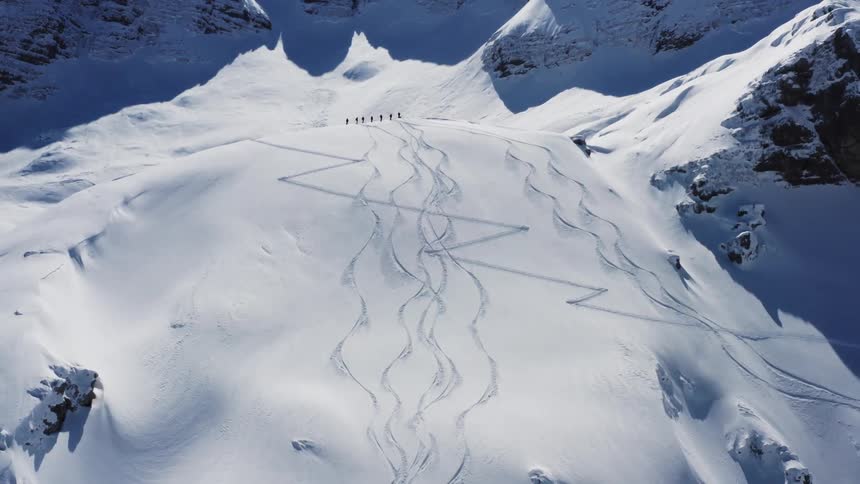 Aerial view of a mountainous landscape during winter is displayed