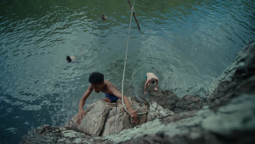 Youths swim to cliff and climb it out of the water