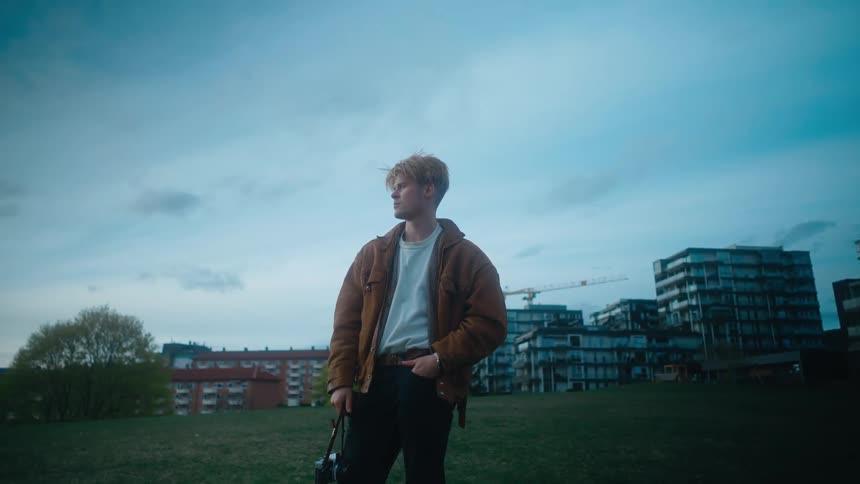 A man standing outside on a grassy lawn