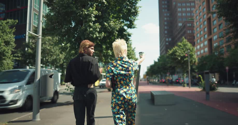 Two friends are catching up with each other and walking outside