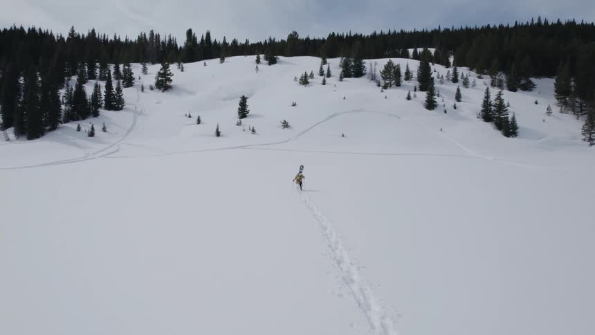 A person is skiing through a mountainous area during winter