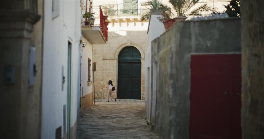 A woman is walking through a city during the spring time