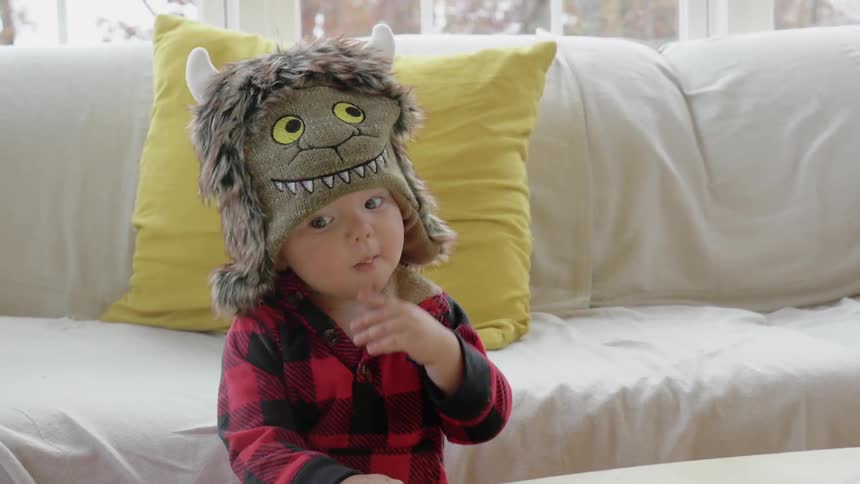 A child wearing a hat eats something