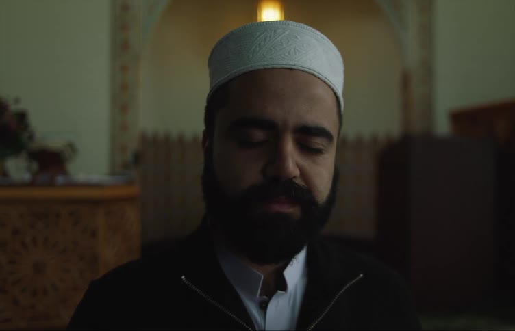 Religious leader in place of worship closes his eyes