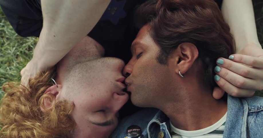 Boyfriend and girlfriend are kissing and smoking outdoors