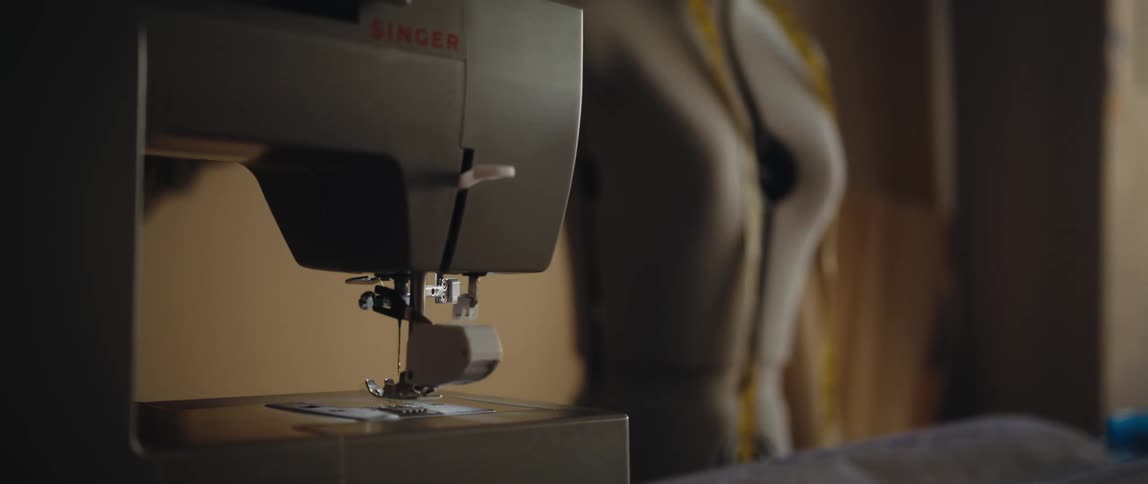 A sewing machine and a seamstress mannequin in a sewing room