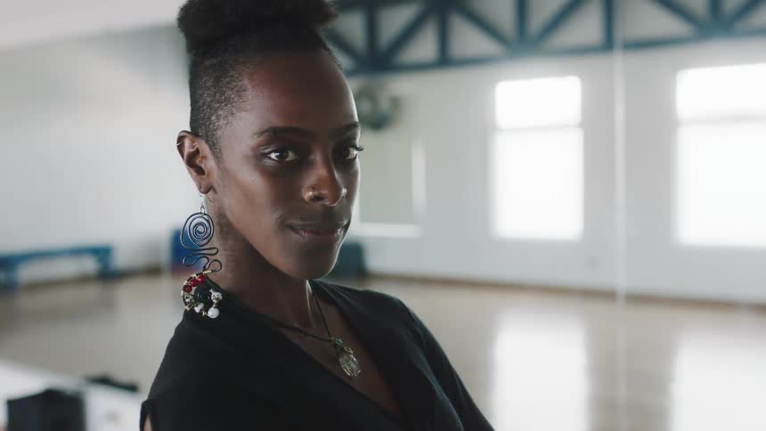 A young black woman is posing for the camera