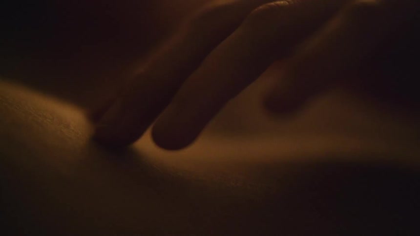 A womans hand moves across the skin