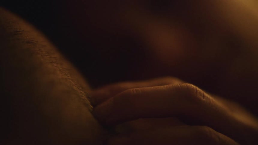A woman caresses her boyfriends stubble on his cheek