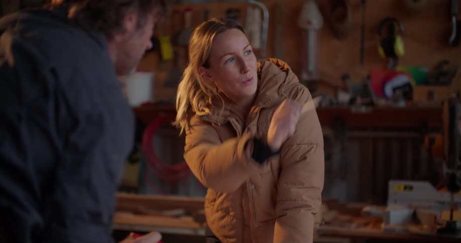 A woman talking with her coworker in a workshop