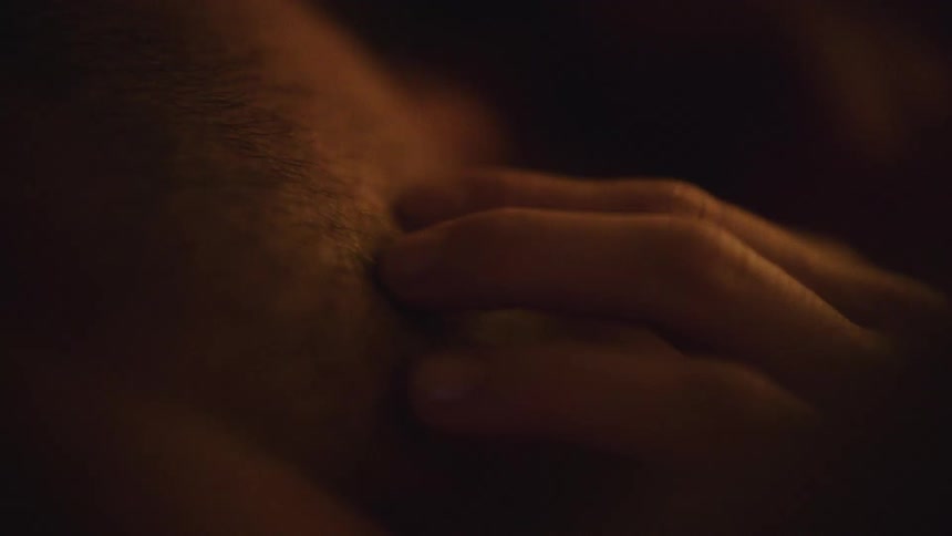 A woman slowly caresses someones skin