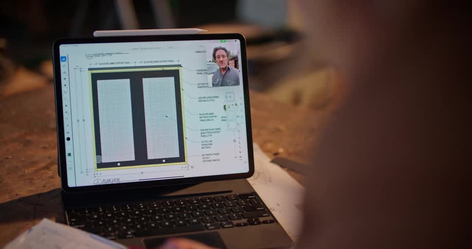 A woman is on her laptop inside her room