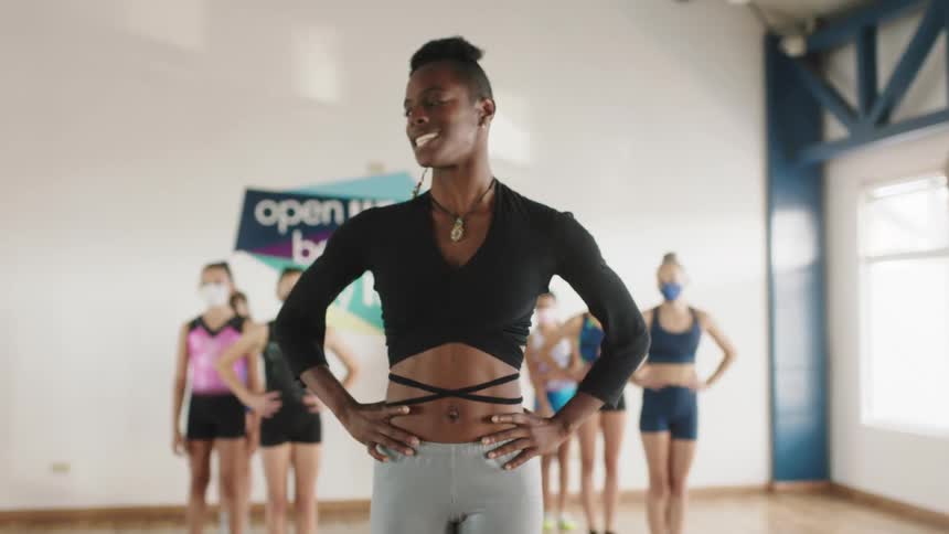 Black woman is teaching a dance class with other girls