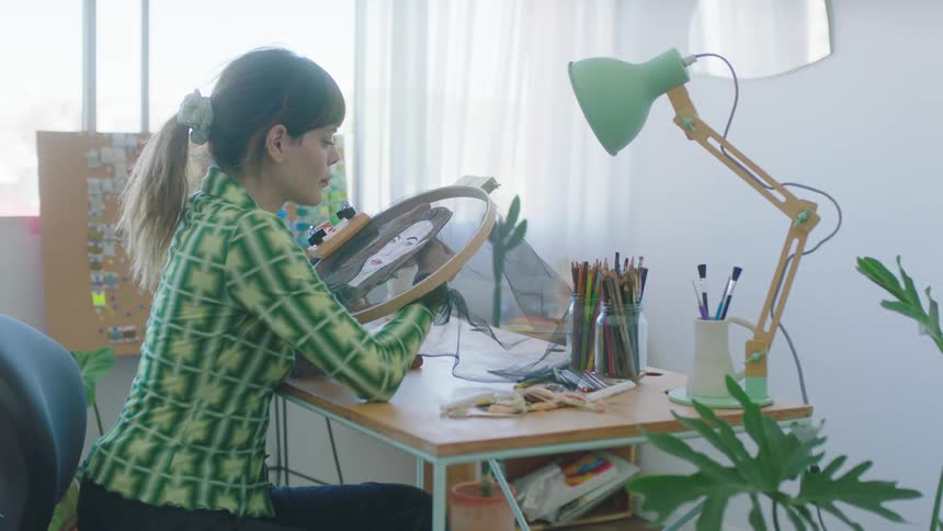 A young woman is sitting down working in the office