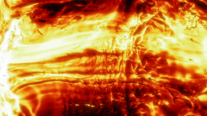 Flaming liquid moves together and rolls over objects