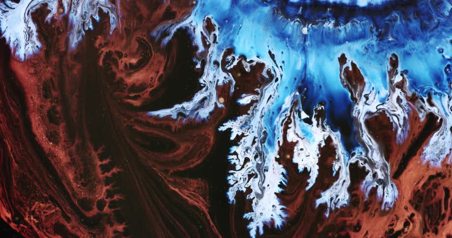 Waves of bright blue ink flowing over dark red maroon liquid ink