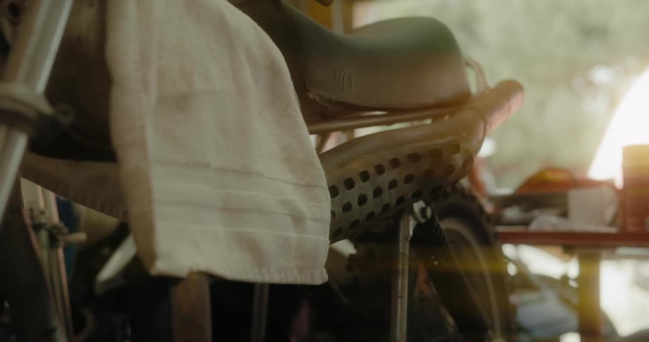 White towel over a motorcycle parked inside a garage at home