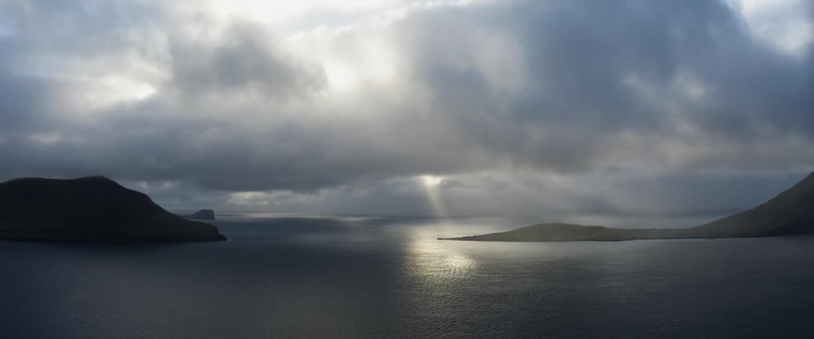 A ray of sunlight breaks through the clouds and shines upon the frozen water