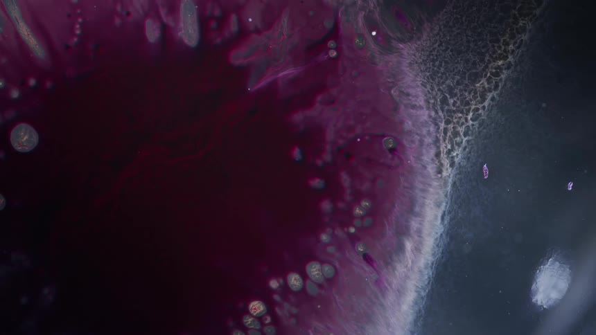 Flowing and bubbling maroon liquid