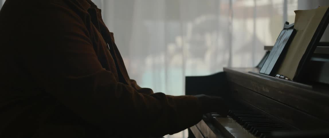 A man is playing the piano indoors