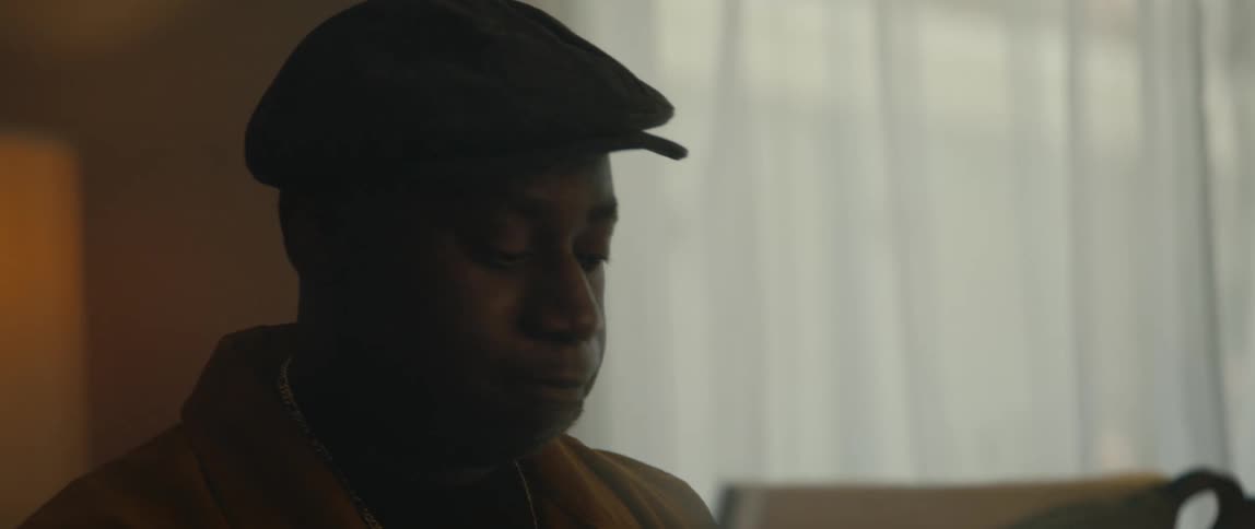 A man is sitting in a room in his house