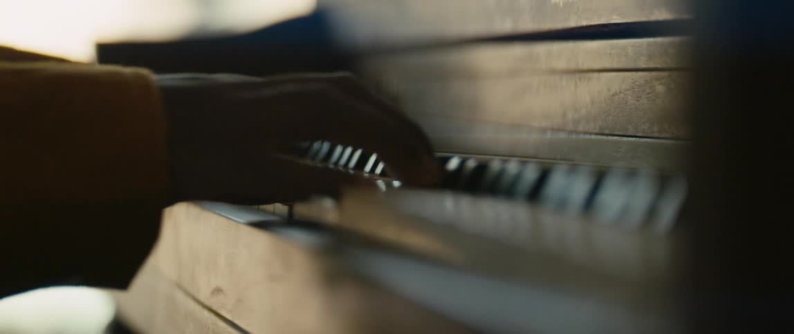 Close up view of a persons hands while playing the piano