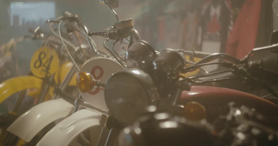 A lot of motorcycles are left in a garage
