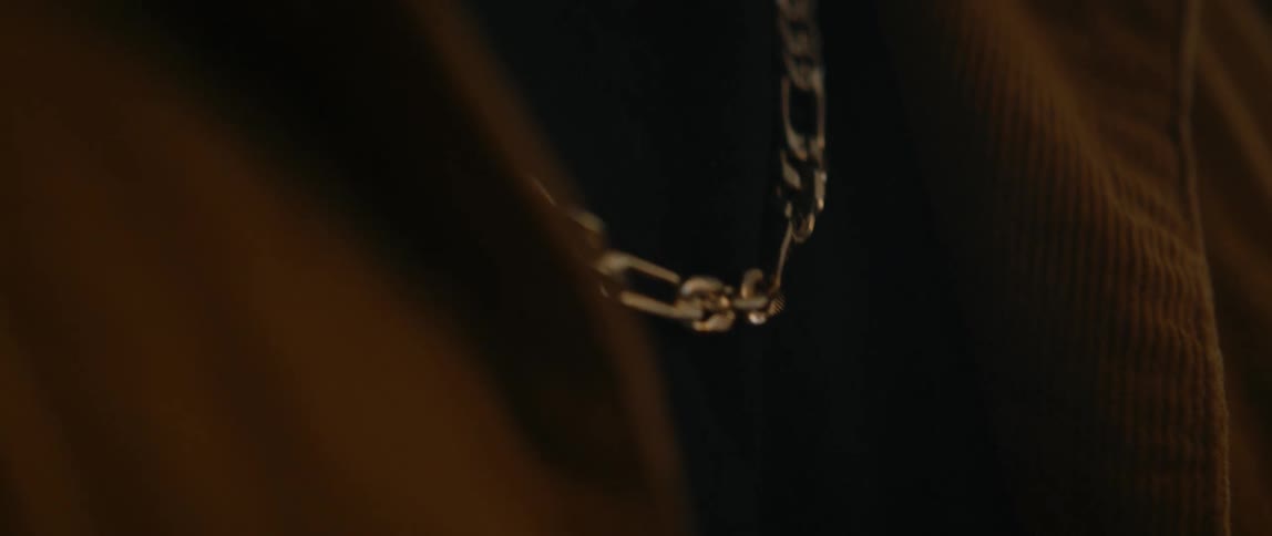 Close up view of a person wearing a necklace