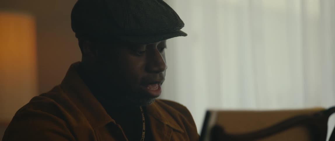 A man is singing while he plays the piano