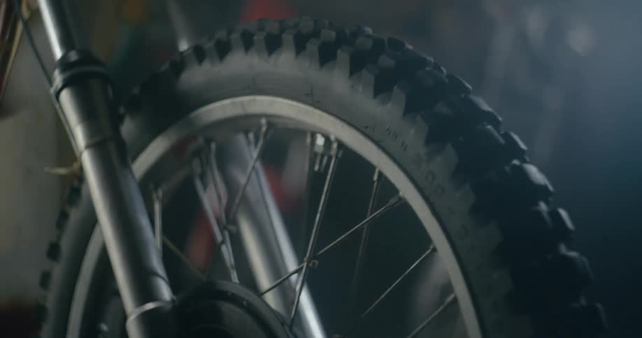A person is spinning a wheel on a bicycle