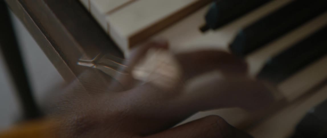 A hand playing piano keys