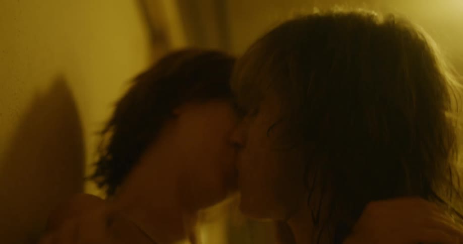 Young couple passionately kissing against a hallway wall
