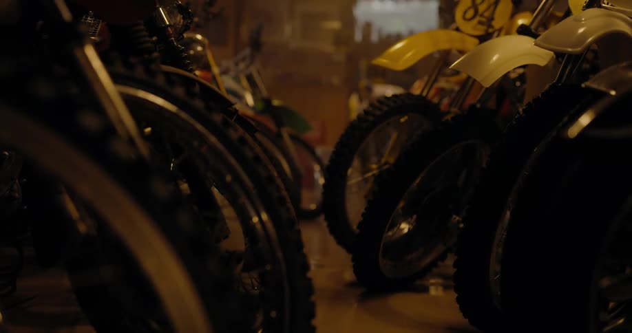 Motorcycles are lined up in a display in a dealership