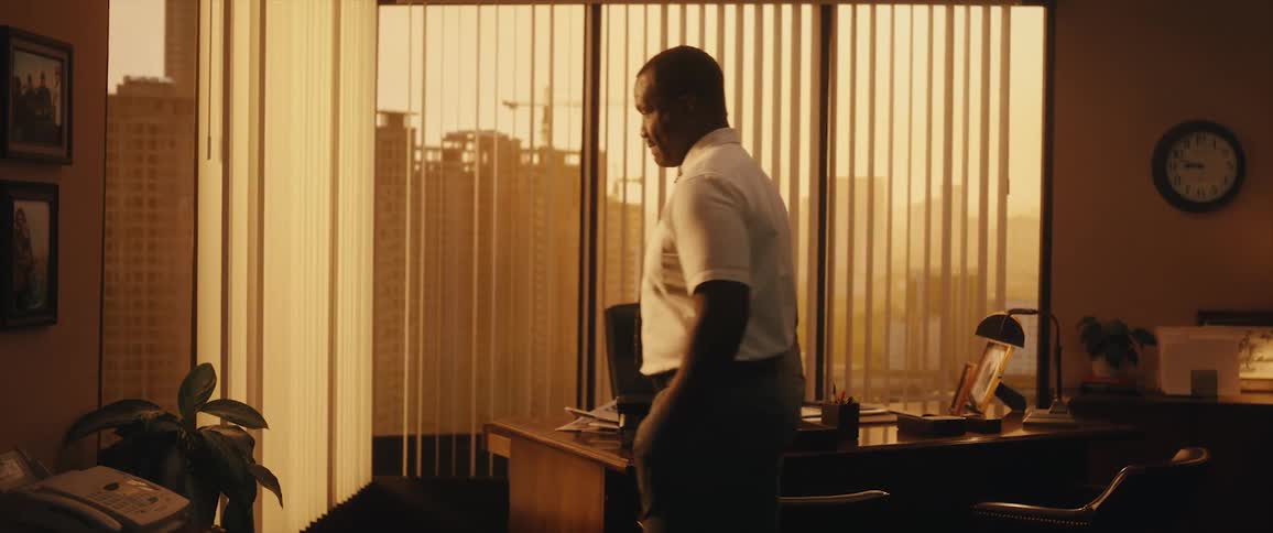 Two coworkers are talking together in an office