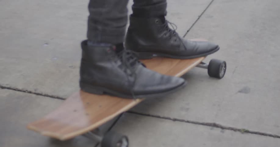 A person is skateboarding on the sidewalk