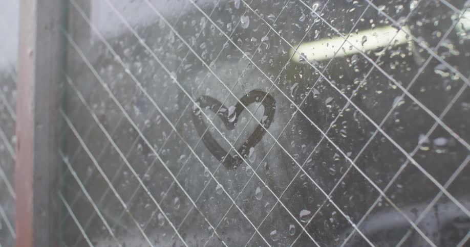 A window has a heart traced inside