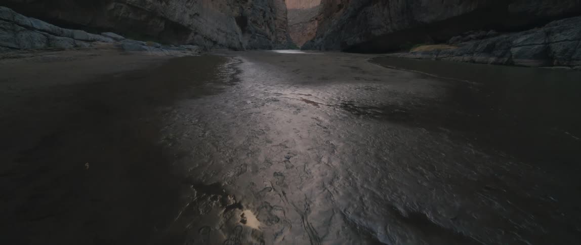 A view of a river at the base of a canyon