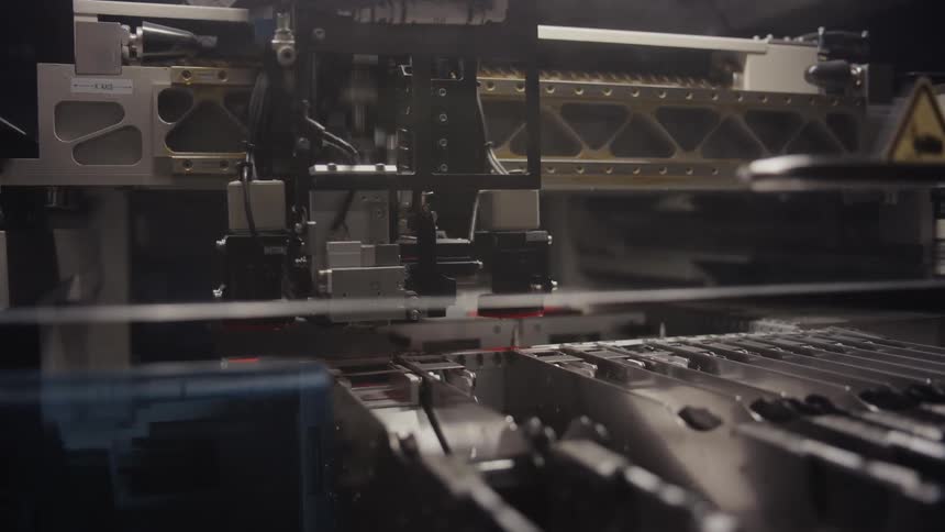 Close up of an automated machine assembling and sorting pieces on a factory